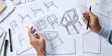 Close up on the hands of a product designer, holding design sketches of a new chair made from recycled materials